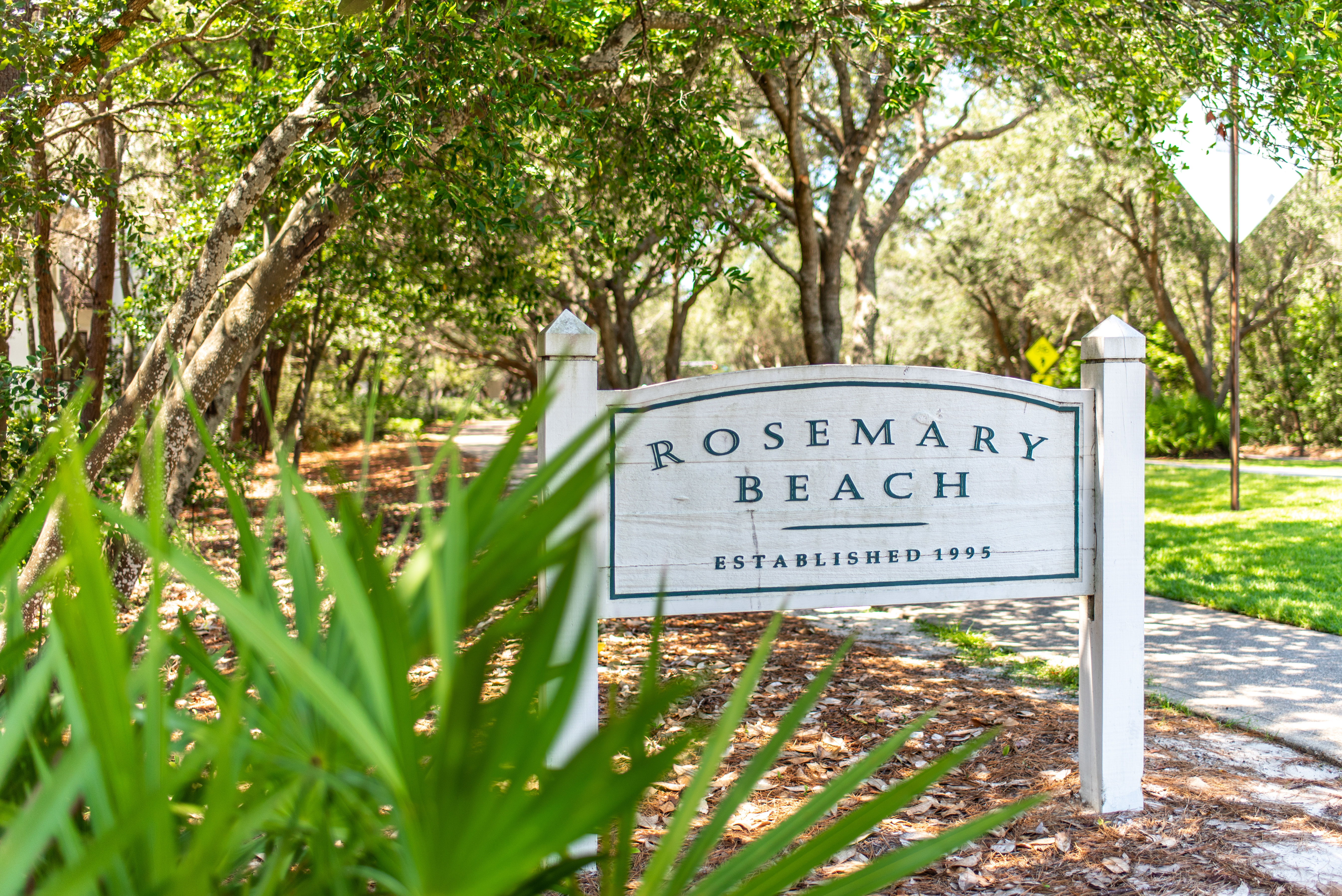 The Rosemary Beach town sign along the oak lined street